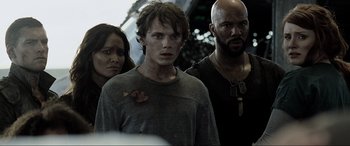 Movie still from “Terminator Salvation” (2009), directed by McG – A group of people standing next to each other; Close Up shot, Over the shoulder angle