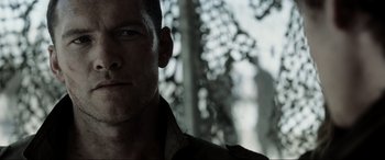 Movie still from “Terminator Salvation” (2009), directed by McG – A man's face with trees in the background; Close Up shot, Over the shoulder angle