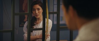 Movie still from “Tetris” (2023), directed by Jon S. Baird – A woman looking in the mirror in front of a window; Close Up shot, Over the shoulder angle