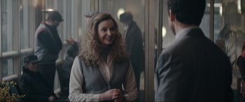 Movie still from “Tetris” (2023), directed by Jon S. Baird – A woman standing in front of a mirror talking to a man; Medium shot, Over the shoulder angle