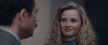 Movie still from “Tetris” (2023), directed by Jon S. Baird – A person looking at another person; Close Up shot, Over the shoulder angle