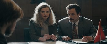 Movie still from “Tetris” (2023), directed by Jon S. Baird – A man and a woman sitting in front of a table; Close Up shot, Low angle