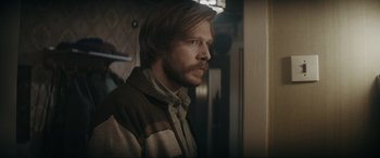 Movie still from “Tetris” (2023), directed by Jon S. Baird – A person wearing a sweater; Close Up shot, Over the shoulder angle