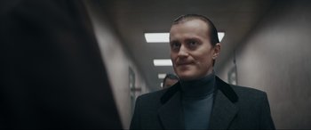 Movie still from “Tetris” (2023), directed by Jon S. Baird – A person wearing a suit and tie; Close Up shot, Low angle