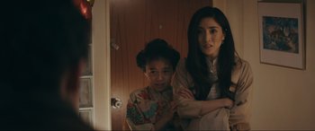 Movie still from “Tetris” (2023), directed by Jon S. Baird – A woman and a young girl are standing next to each other; Medium shot, Over the shoulder angle