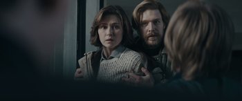 Movie still from “Tetris” (2023), directed by Jon S. Baird – A man and a woman looking in a mirror; Medium shot, Over the shoulder angle