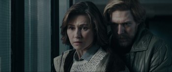 Movie still from “Tetris” (2023), directed by Jon S. Baird – A person standing next to another person; Close Up shot, Over the shoulder angle