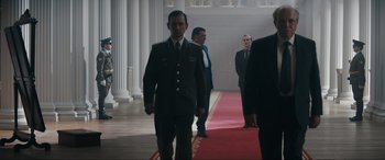 Movie still from “Tetris” (2023), directed by Jon S. Baird – A group of men standing next to each other on a red carpet; Medium shot, Low angle