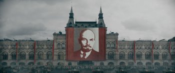 Movie still from “Tetris” (2023), directed by Jon S. Baird – A large picture of lenin on the side of a building; Extreme Wide shot, Low angle