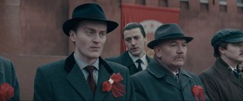 Movie still from “Tetris” (2023), directed by Jon S. Baird – A group of men wearing suits and hats; Close Up shot, Over the shoulder angle