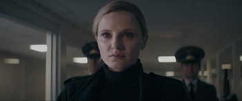 Movie still from “Tetris” (2023), directed by Jon S. Baird – A person wearing a black shirt; Close Up shot, Low angle