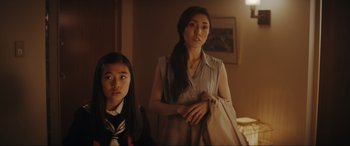 Movie still from “Tetris” (2023), directed by Jon S. Baird – A woman and a girl standing next to each other in a room; Medium shot, Over the shoulder angle