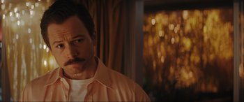 Movie still from “Tetris” (2023), directed by Jon S. Baird – A person wearing a shirt and a tie; Close Up shot, Low angle