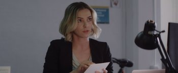 Movie still from “That's Amor” (2022), directed by Shaun Paul Piccinino – A woman holding a piece of paper in her hand; Close Up shot, Over the shoulder angle