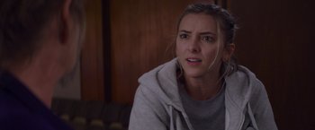 Movie still from “That's Amor” (2022), directed by Shaun Paul Piccinino – A person wearing a hoodie; Close Up shot, Over the shoulder angle