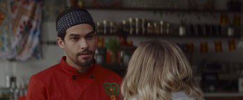 Movie still from “That's Amor” (2022), directed by Shaun Paul Piccinino – A man and a woman are talking to each other in a kitchen; Close Up shot, Over the shoulder angle