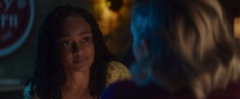 Movie still from “That's Amor” (2022), directed by Shaun Paul Piccinino – A person in a dark room; Close Up shot, Over the shoulder angle