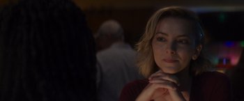Movie still from “That's Amor” (2022), directed by Shaun Paul Piccinino – A person with her hand on her chin; Close Up shot, Over the shoulder angle