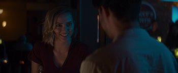 Movie still from “That's Amor” (2022), directed by Shaun Paul Piccinino – A woman smiles at a man in the mirror; Close Up shot, Over the shoulder angle
