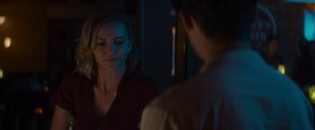 Movie still from “That's Amor” (2022), directed by Shaun Paul Piccinino – A woman standing in front of a mirror looking at a man; Close Up shot, Over the shoulder angle