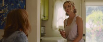 Movie still from “That's Amor” (2022), directed by Shaun Paul Piccinino – A woman is holding a jar in front of a bathroom mirror; Close Up shot, Over the shoulder angle