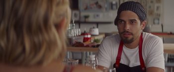 Movie still from “That's Amor” (2022), directed by Shaun Paul Piccinino – A man and a woman are sitting at a table; Close Up shot, Over the shoulder angle