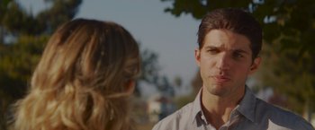 Movie still from “That's Amor” (2022), directed by Shaun Paul Piccinino – A man and a woman talking to each other outside; Close Up shot, Over the shoulder angle