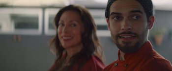 Movie still from “That's Amor” (2022), directed by Shaun Paul Piccinino – A woman and a man smiling for the camera; Close Up shot, Over the shoulder angle