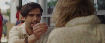 Movie still from “That's Amor” (2022), directed by Shaun Paul Piccinino – A man and a woman are talking to each other; Close Up shot, Over the shoulder angle