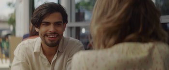 Movie still from “That's Amor” (2022), directed by Shaun Paul Piccinino – A man and a woman are sitting at a table; Close Up shot, Over the shoulder angle
