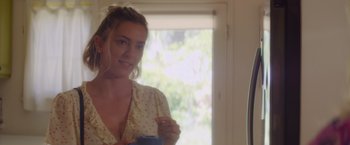 Movie still from “That's Amor” (2022), directed by Shaun Paul Piccinino – A beautiful young lady standing in front of a window; Close Up shot, Over the shoulder angle