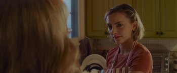 Movie still from “That's Amor” (2022), directed by Shaun Paul Piccinino – A woman is looking at her reflection in a mirror; Close Up shot, Over the shoulder angle