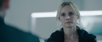 Movie still from “The 355” (2022), directed by Simon Kinberg – A person wearing a black jacket; Close Up shot, Over the shoulder angle