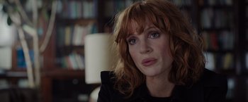 Movie still from “The 355” (2022), directed by Simon Kinberg – A person wearing a black jacket; Close Up shot, Over the shoulder angle