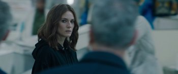 Movie still from “The 355” (2022), directed by Simon Kinberg – A woman in a black shirt is looking at a man in a gray suit; Close Up shot, Over the shoulder angle