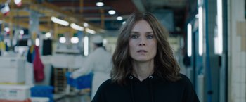 Movie still from “The 355” (2022), directed by Simon Kinberg – A person with long hair; Close Up shot, Over the shoulder angle