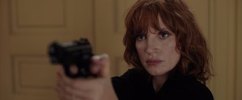 Movie still from “The 355” (2022), directed by Simon Kinberg – A person holding a gun; Close Up shot, Over the shoulder angle