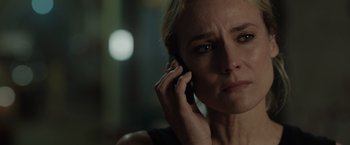 Movie still from “The 355” (2022), directed by Simon Kinberg – A person talking on a cell phone; Close Up shot, Over the shoulder angle
