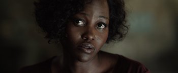 Movie still from “The 355” (2022), directed by Simon Kinberg – A person looking at the camera; Close Up shot, Over the shoulder angle