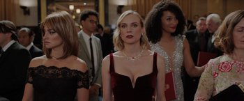 Movie still from “The 355” (2022), directed by Simon Kinberg – A group of people standing in a room; Medium shot, Over the shoulder angle