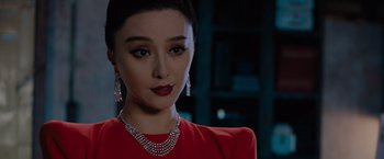 Movie still from “The 355” (2022), directed by Simon Kinberg – A person wearing a necklace and earrings; Close Up shot, Over the shoulder angle