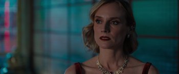 Movie still from “The 355” (2022), directed by Simon Kinberg – A person wearing a necklace; Close Up shot, Over the shoulder angle