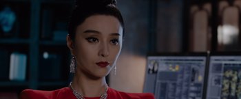 Movie still from “The 355” (2022), directed by Simon Kinberg – A person wearing a red dress; Close Up shot, Over the shoulder angle