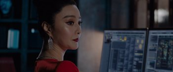 Movie still from “The 355” (2022), directed by Simon Kinberg – A person wearing a red dress; Close Up shot, Over the shoulder angle