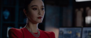 Movie still from “The 355” (2022), directed by Simon Kinberg – A person wearing a red dress; Close Up shot, Over the shoulder angle