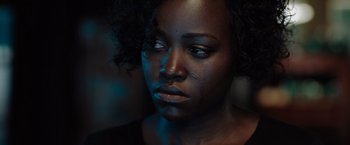 Movie still from “The 355” (2022), directed by Simon Kinberg – A person looking at the camera; Close Up shot, Over the shoulder angle