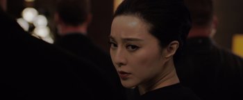 Movie still from “The 355” (2022), directed by Simon Kinberg – A person wearing a black shirt; Close Up shot, Over the shoulder angle