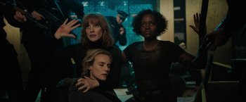 Movie still from “The 355” (2022), directed by Simon Kinberg – A group of women standing next to each other in a room; Medium shot, High angle