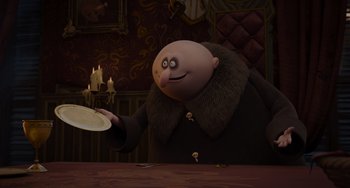 Movie still from “The Addams Family 2” (2021), directed by Greg Tiernan – An animated character is holding a plate in his hand; Medium shot, Over the shoulder angle