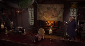 Movie still from “The Addams Family 2” (2021), directed by Greg Tiernan – A teddy bear laying in front of a fire place; Extreme Wide shot, High angle